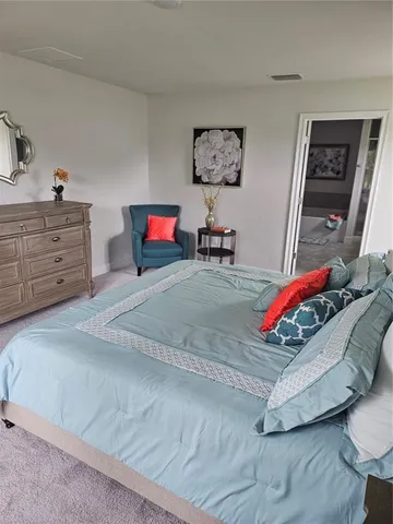 a bedroom with furniture and a dresser
