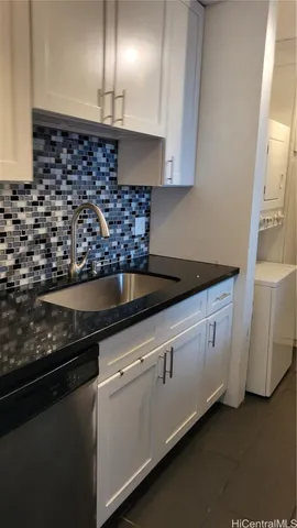 a bathroom with a granite countertop sink a toilet and a mirror