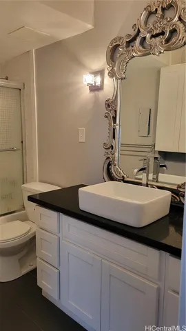 a bathroom with a toilet a sink and shower
