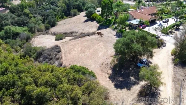 an aerial view of house with yard and mountain view in back