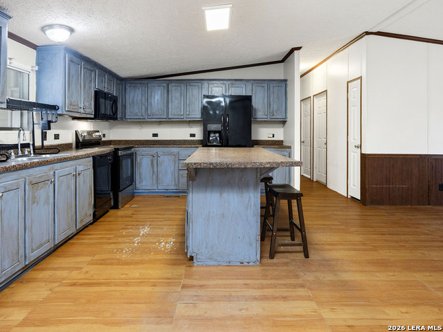 135 Savannah Ridge Von Ormy, TX 78073 - Photo 34 of 45 a kitchen with stainless steel appliances granite countertop a sink wooden cabinets and granite counter tops