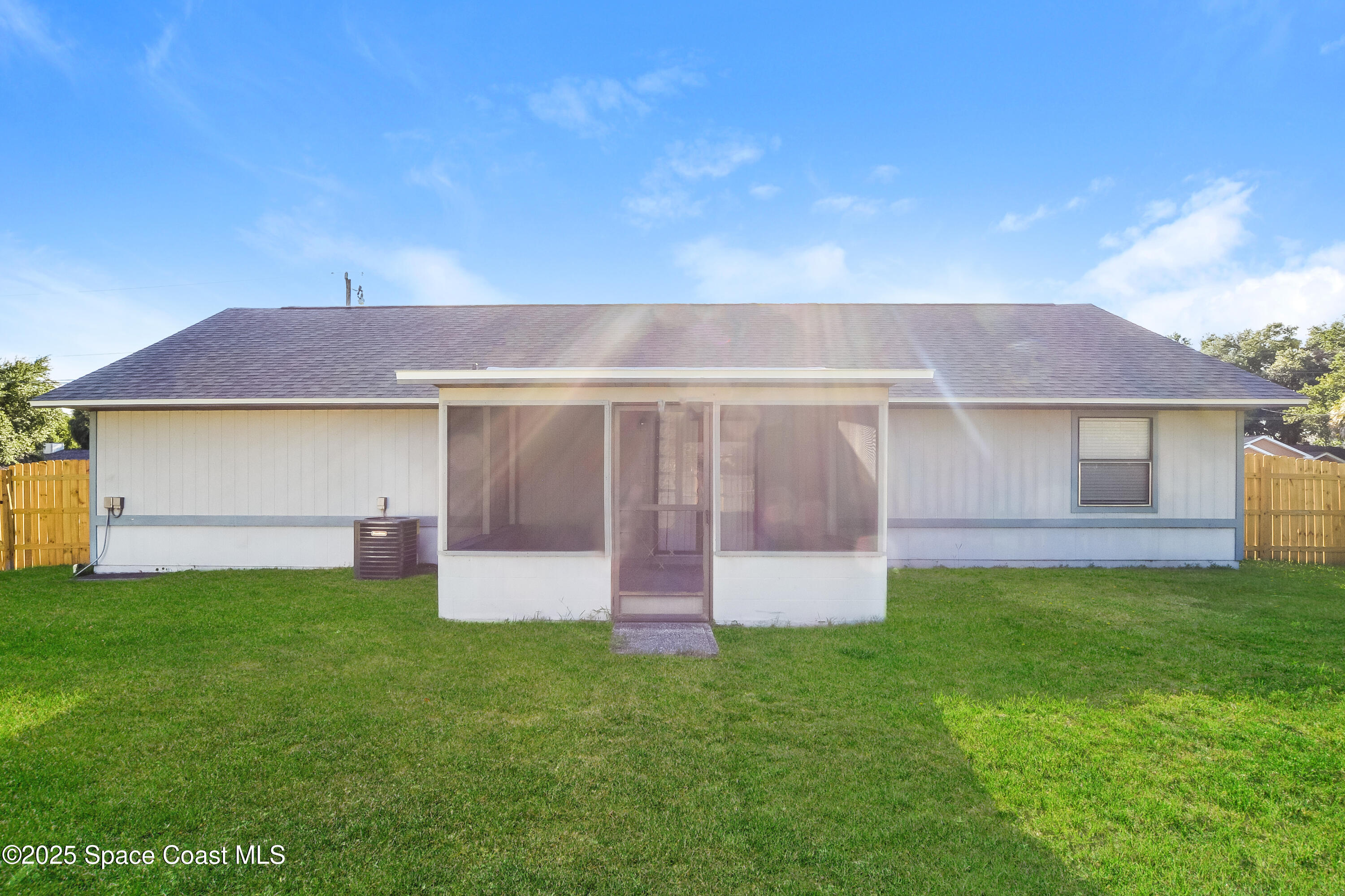 6005 Keystone Avenue Cocoa, FL 32927 - Photo 14 of 16 a front view of a house with a yard and garage
