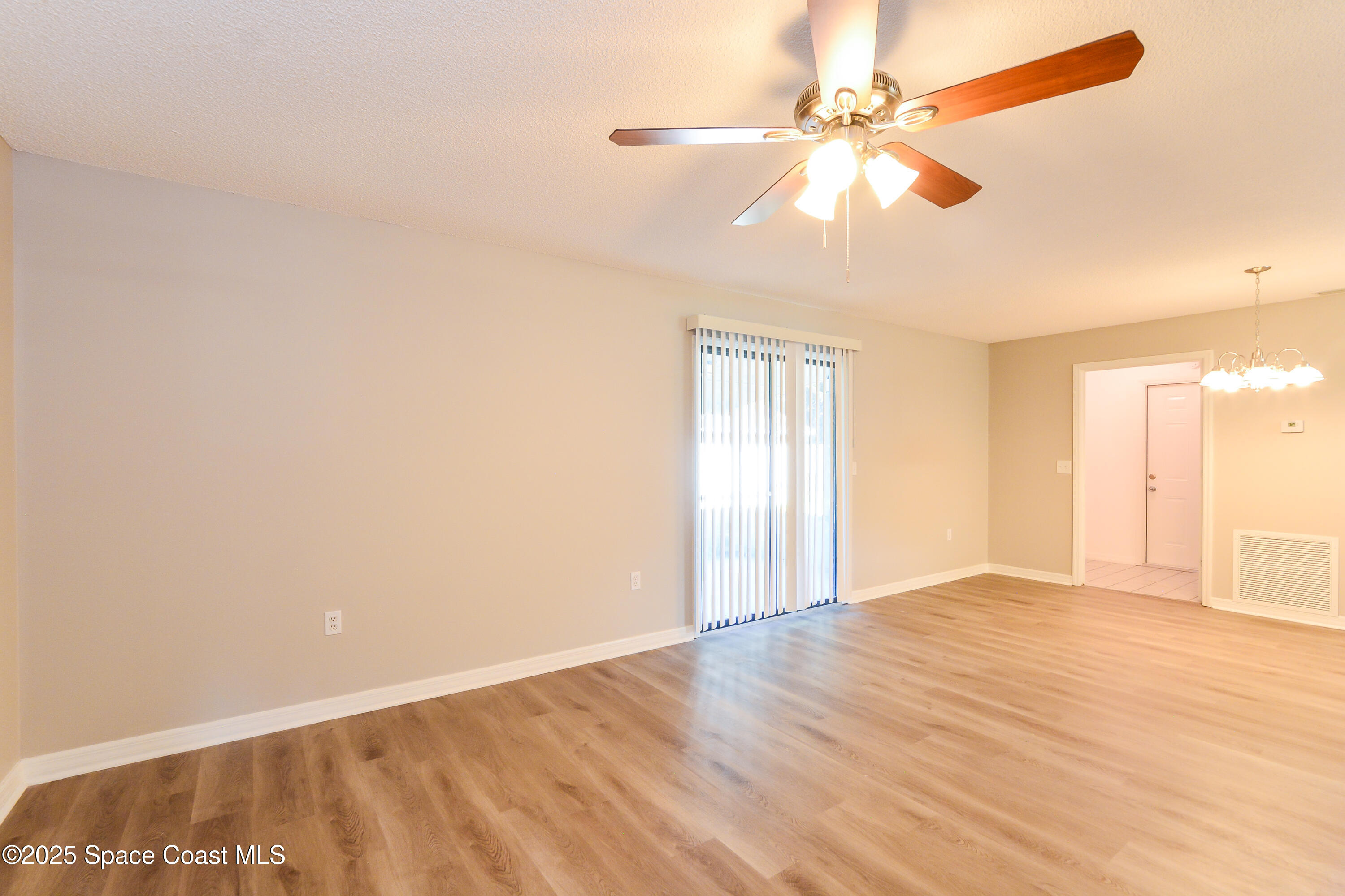 6005 Keystone Avenue Cocoa, FL 32927 - Photo 4 of 16 an empty room with windows and fan