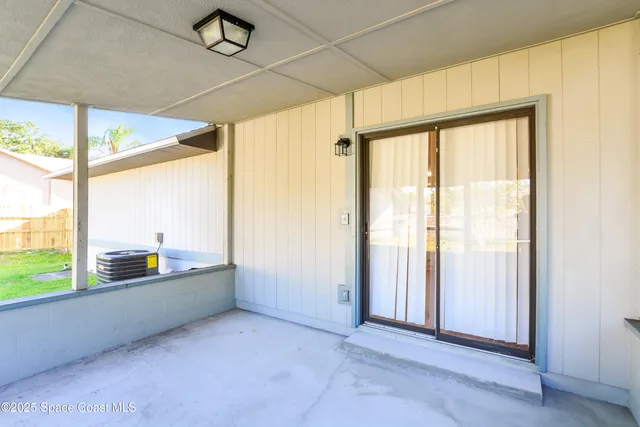 an empty room with large windows