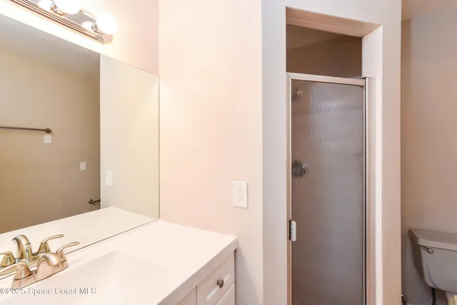 a bedroom with a bed and a bathroom