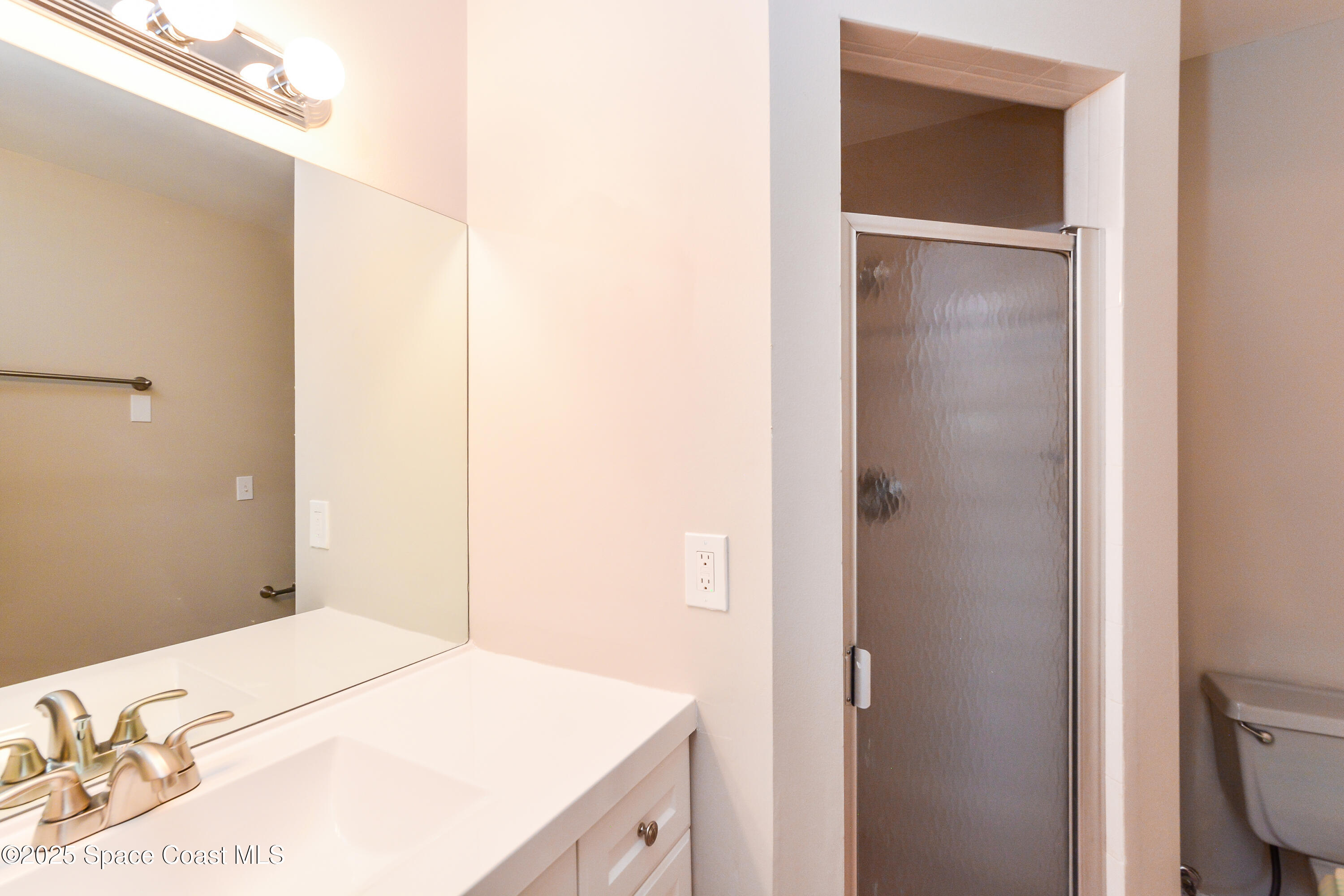 6005 Keystone Avenue Cocoa, FL 32927 - Photo 9 of 16 a bedroom with a bed and a bathroom