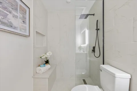 a white toilet sitting next to a bathroom sink