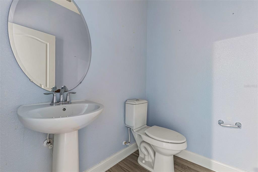 281 Ancona Avenue DeBary, FL 32713 - Photo 11 of 65 a bathroom with a toilet sink and mirror