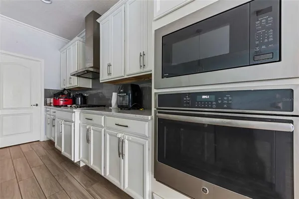 a kitchen with stainless steel appliances granite countertop a stove microwave and cabinets