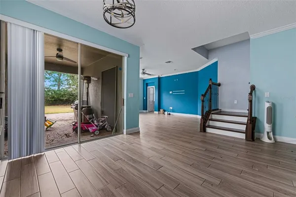 a view of a kitchen with furniture and wooden floor