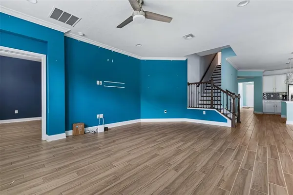 a view of an empty room and wooden floor