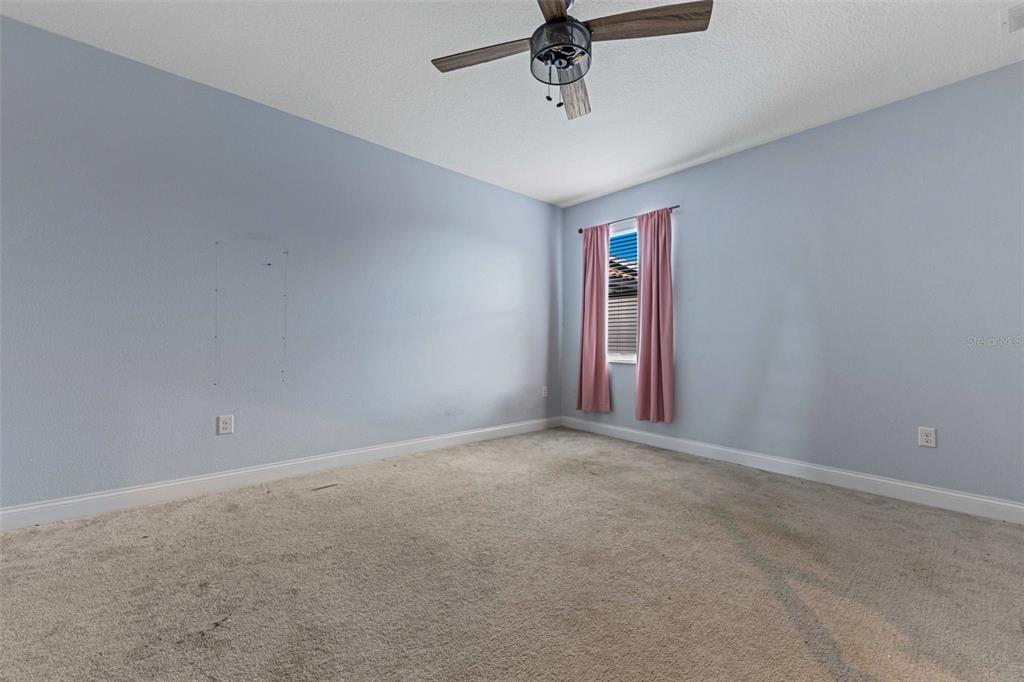 281 Ancona Avenue DeBary, FL 32713 - Photo 28 of 65 en empty room with windows and ceiling fan