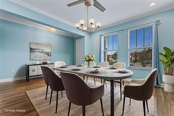 a view of a dining room with furniture a chandelier and wooden floor