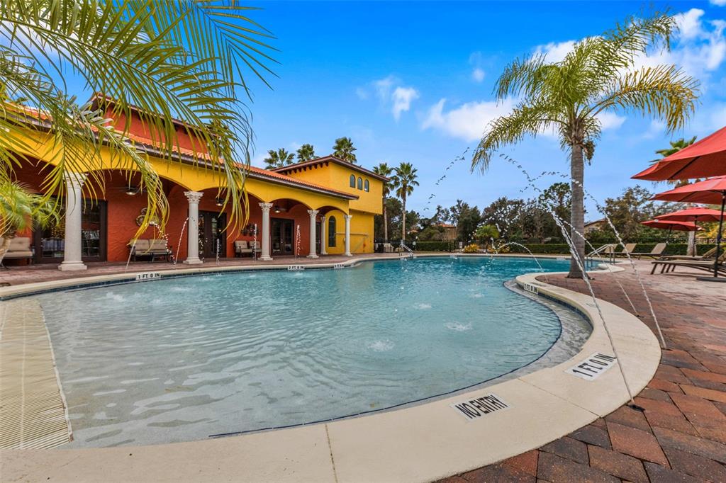 281 Ancona Avenue DeBary, FL 32713 - Photo 57 of 65 a view of a swimming pool with a lawn chairs under palm trees