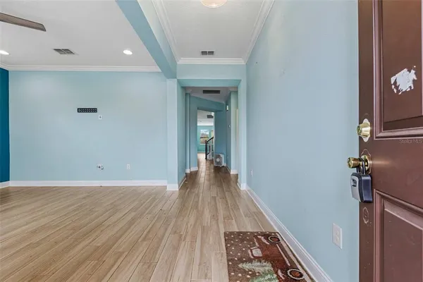 a view of a hallway with wooden floor