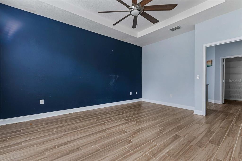 281 Ancona Avenue DeBary, FL 32713 - Photo 9 of 65 a view of an empty room with wooden floor and a chandelier fan