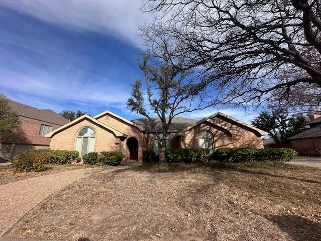 a view of house with a yard