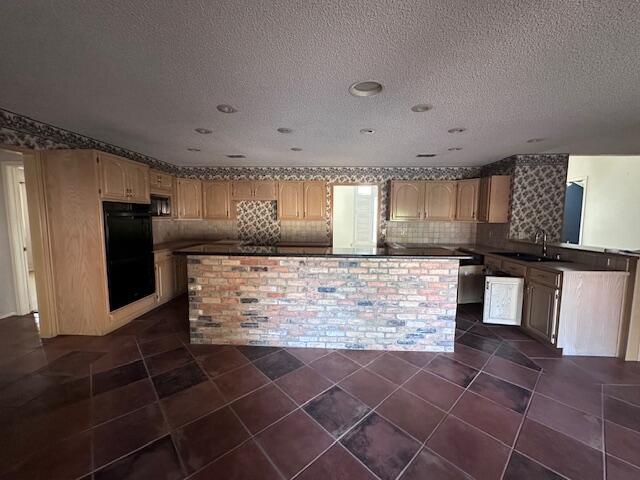 4610 91st Street Lubbock, TX 79424 - Photo 2 of 26 a kitchen with kitchen island a counter top space a stove and refrigerator