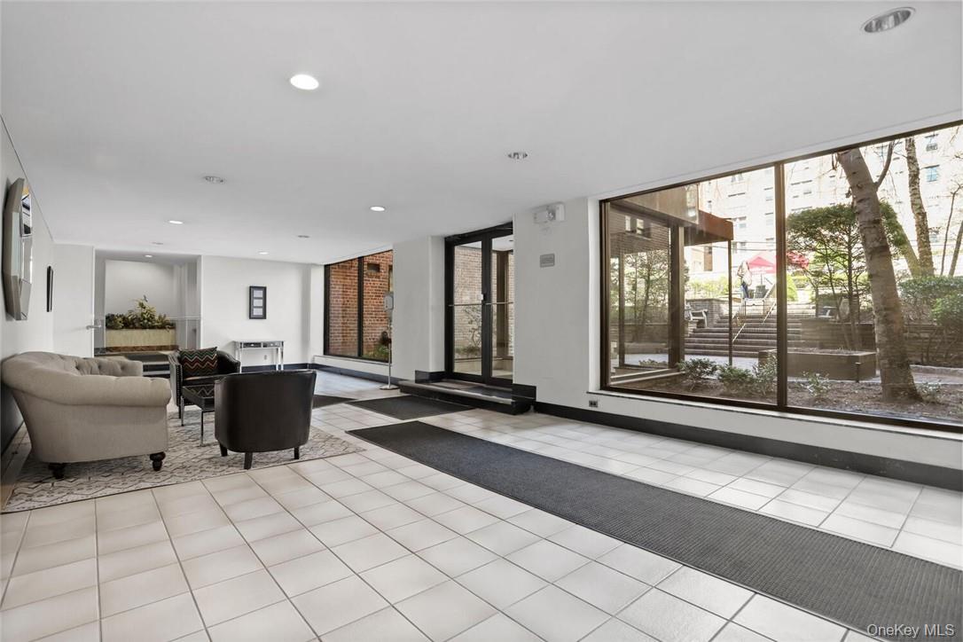 10 Franklin Avenue, Unit 1EFF White Plains, NY 10601 - Photo 11 of 13 a living room with furniture and large windows