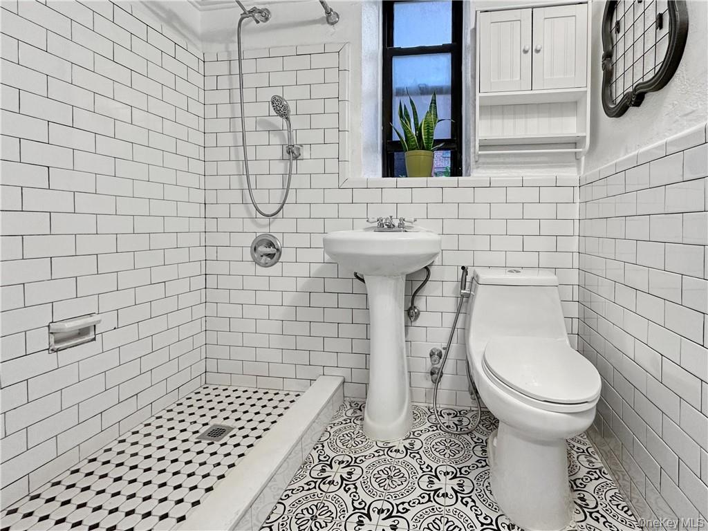 10 Franklin Avenue, Unit 1EFF White Plains, NY 10601 - Photo 6 of 13 a bathroom with a toilet and a shower