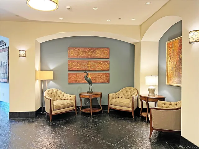 a view of a livingroom with furniture wooden floor and a ceiling fan