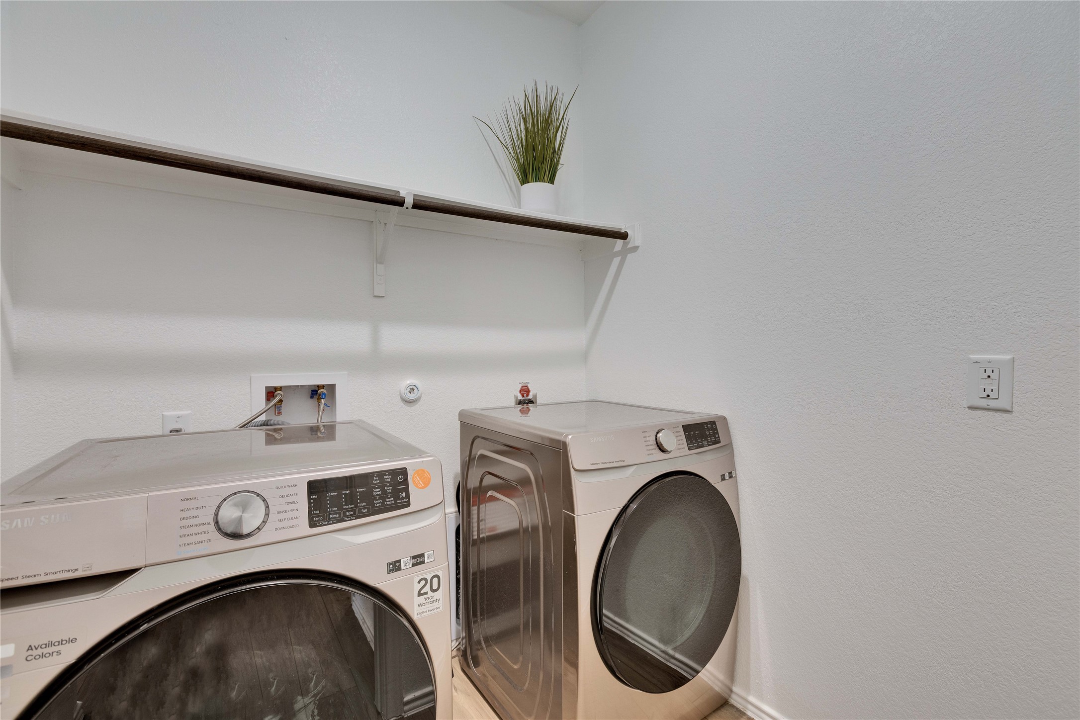 206 Canley Loop Hutto, TX 78634 - Photo 4 of 31 Laundry room featuring front loading washing machine and dryer.