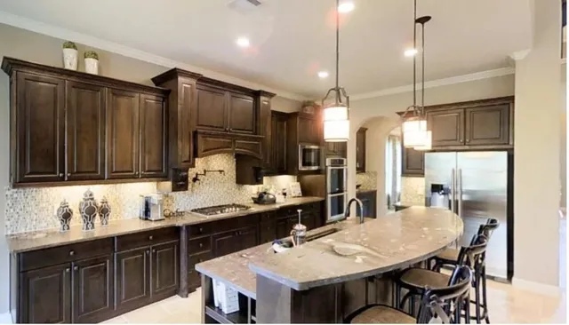 a kitchen with a table chairs sink and cabinets