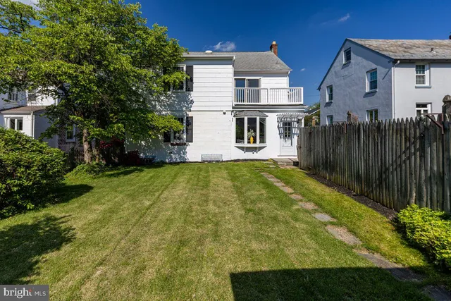 a view of house with yard and sitting area