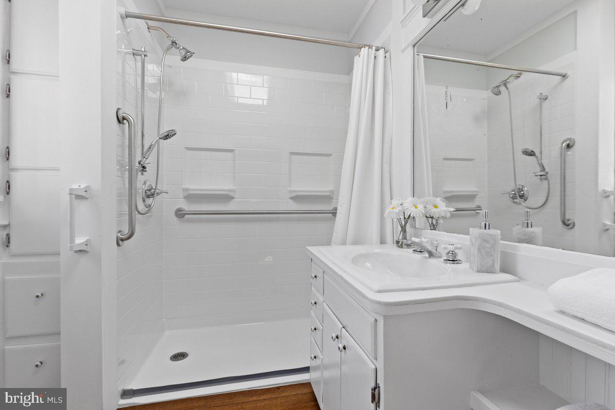 122 Linden Lane Princeton, NJ 08540 - Photo 7 of 19 a bathroom with a shower sink vanity and mirror