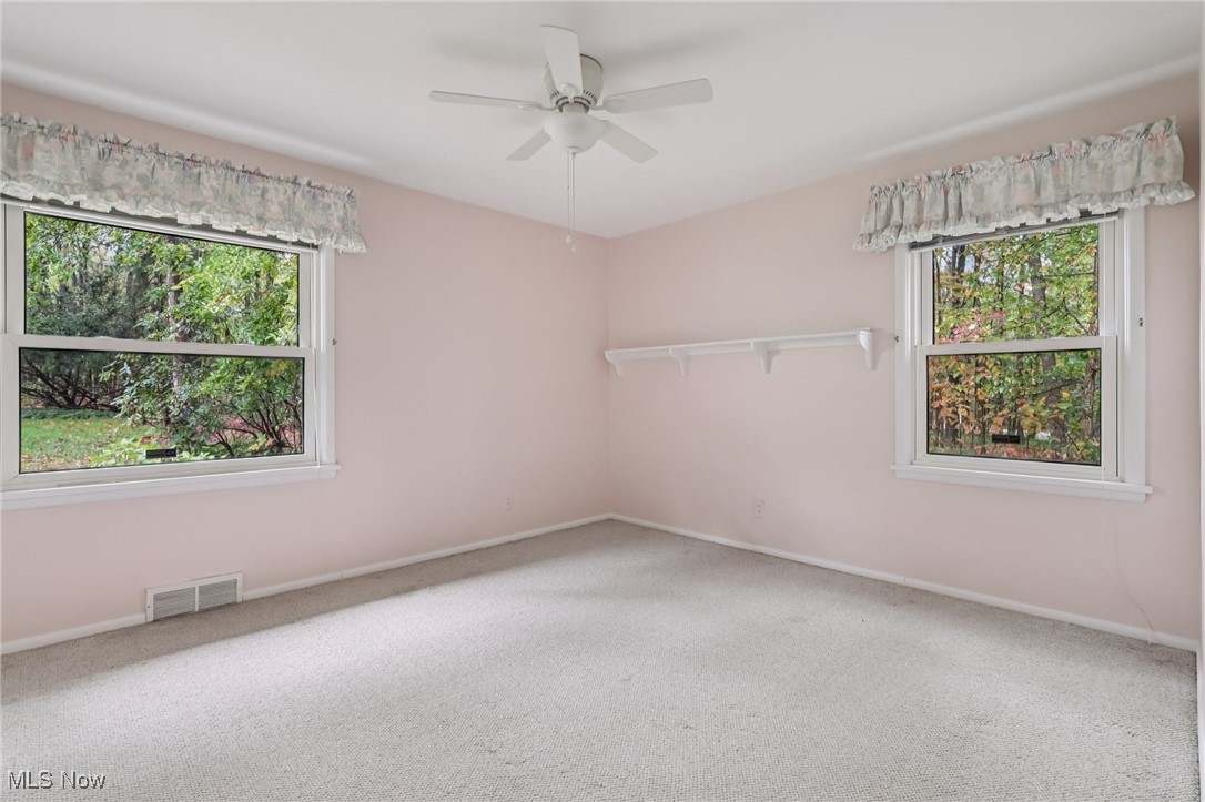 33300 South Woodland Road Cleveland, OH 44124 - Photo 35 of 50 Spare room with carpet floors, plenty of natural light, and a ceiling fan