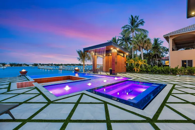 a room with stainless steel appliances kitchen island granite countertop a sink and cabinets