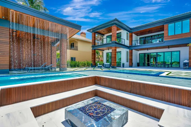 a living room with furniture kitchen view and a large window