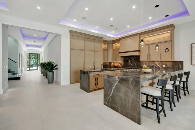 a bathroom with a granite countertop sink mirror and toilet