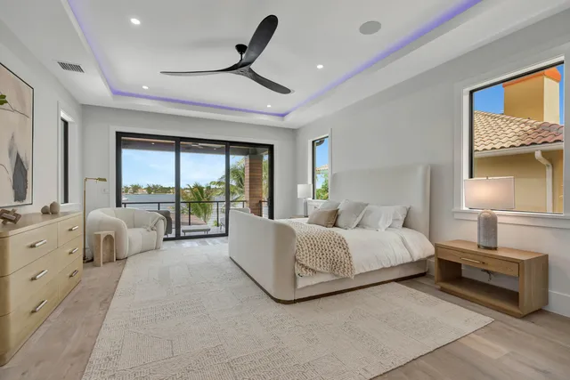 a living room with furniture and large windows