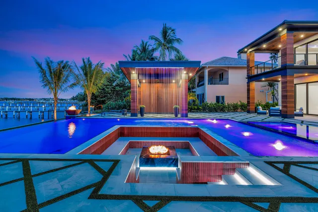 a view of a house with swimming pool and a yard