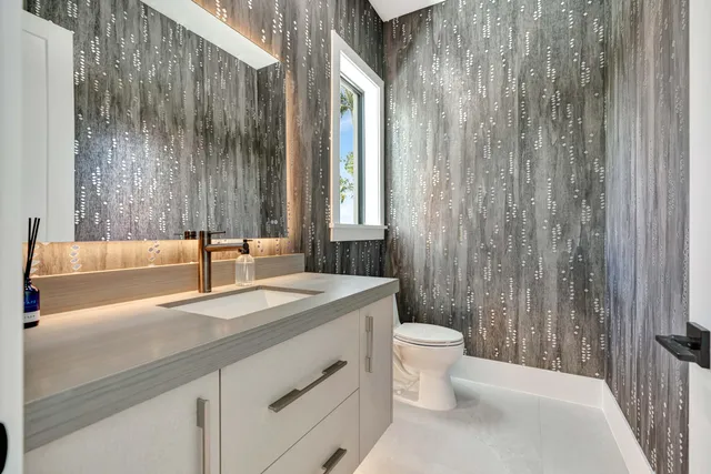 a utility room with stainless steel appliances cabinets and a window