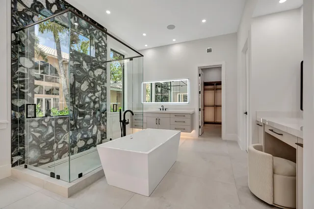 a view of a patio with lawn chairs under an umbrella