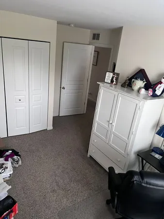 a room with a chair and white walls