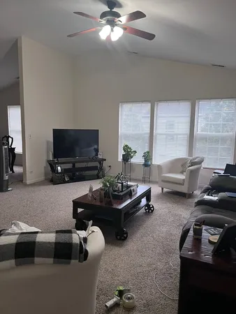 a living room with furniture and a flat screen tv
