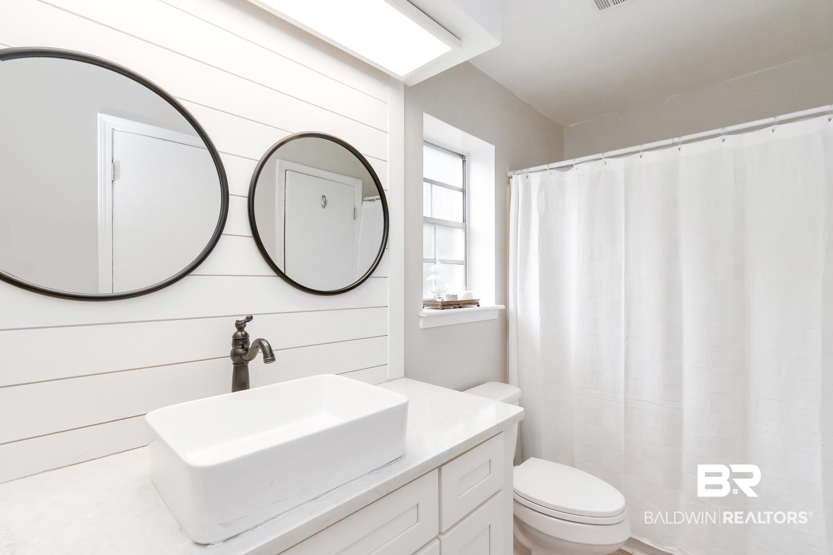 110 Du Rhu Drive, Unit C Mobile, AL 36608 - Photo 11 of 14 Bathroom with wood walls, vanity, and toilet