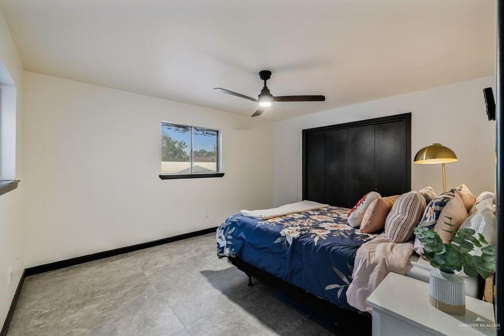 111 South Cox Street Rio Grande City, TX 78582 - Photo 11 of 27 Bedroom featuring baseboards and a ceiling fan