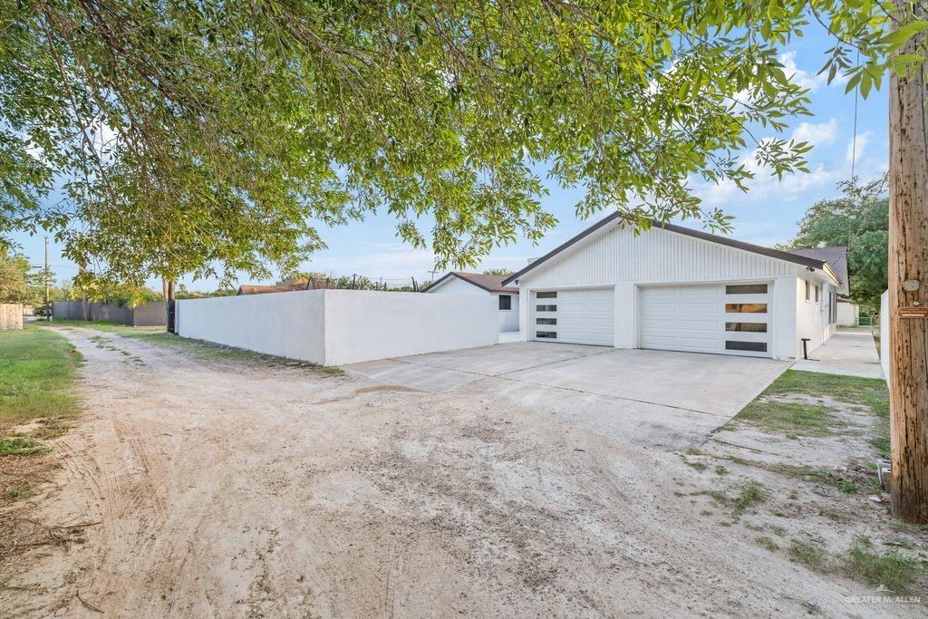 111 South Cox Street Rio Grande City, TX 78582 - Photo 16 of 27 View of property exterior featuring driveway and an outdoor structure