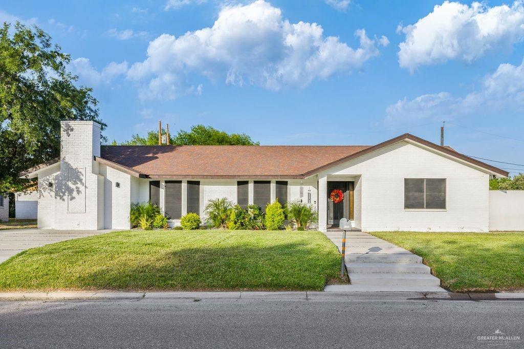 111 South Cox Street Rio Grande City, TX 78582 - Photo 19 of 27 Single story home with a front yard, a chimney, and brick siding