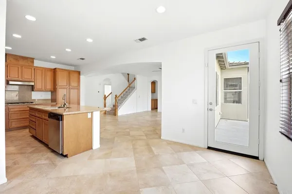 a view of kitchen with refrigerator and microwave