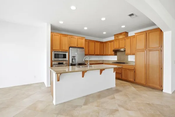a kitchen with stainless steel appliances granite countertop a refrigerator sink and cabinets