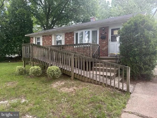 a view of a house with a yard and deck
