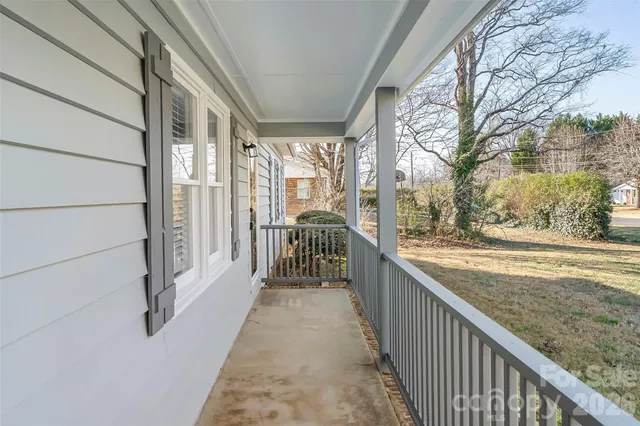 a view of a porch with wooden floor and fence