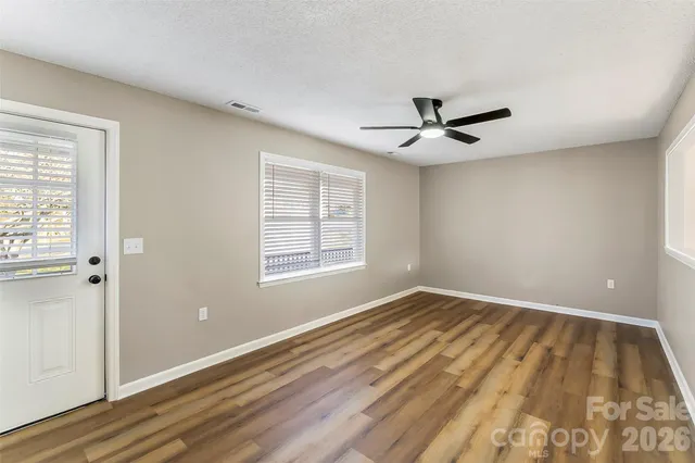 wooden floor in an empty room with a window