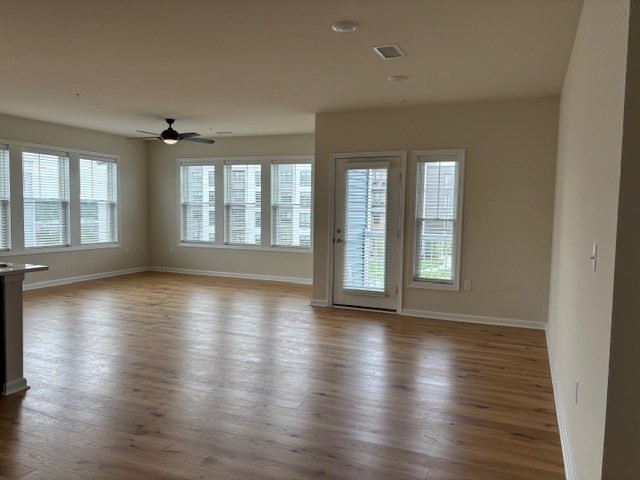 4 Stratton Drive, Unit 301 Woburn, MA 01801 - Photo 12 of 24 a view of an empty room with wooden floor and a window
