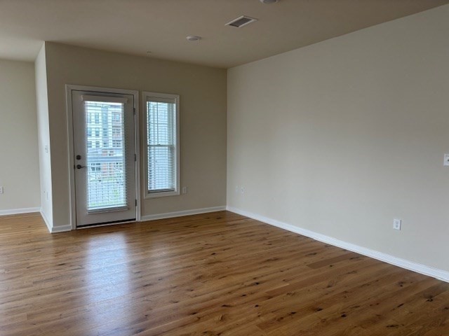 4 Stratton Drive, Unit 301 Woburn, MA 01801 - Photo 13 of 24 a view of an empty room with wooden floor and a window